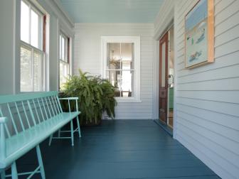 The newly renovated front porch entrance, including blue flooring, from the home that was built in 1873 that Jon Knight renovated with his team as seen on HGTV's Farmhouse Fixer.